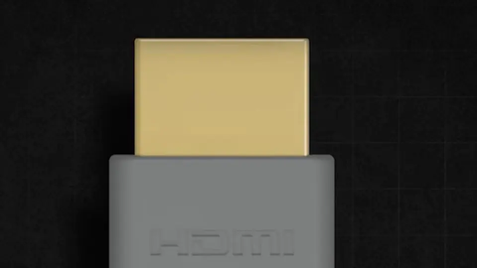 Conector HDMI Kordz de carcasa gris con la punta dorada, de frente sobre fondo negro (ilustración 3D del video «Cables Kordz en México»).